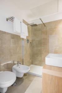 a bathroom with a toilet and a sink and a shower at Lux Caracciolo in Naples