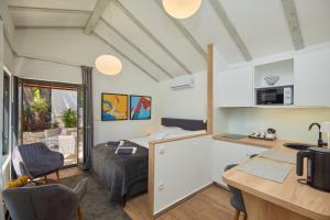 a room with a bed and a kitchen with a counter at Apartments Silva in Dubrovnik
