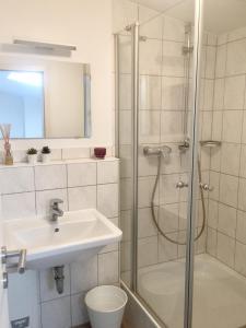 a bathroom with a shower and a sink and a toilet at Römerburg Apartments Burgstraße in Boppard +49 photos
