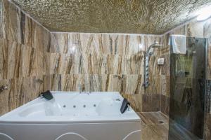 a bathroom with a tub and a shower at Lucky Cave Hotel Cappadocia in Goreme +77 photos