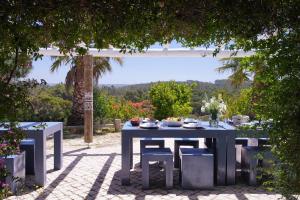 a blue table and chairs on a patio at Monte Velho Retreat Centre in Aljezur