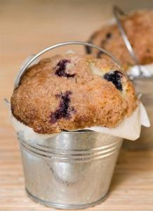 a blueberry muffin in a bucket on a table at Harvey House Bed & Breakfast in Oak Park