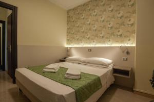 Voodi või voodid majutusasutuse Hotel Dei Fiori toas