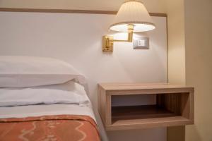 Voodi või voodid majutusasutuse Hotel Dei Fiori toas