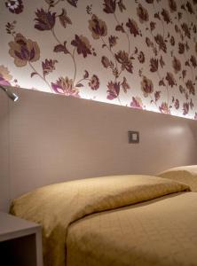 Voodi või voodid majutusasutuse Hotel Dei Fiori toas