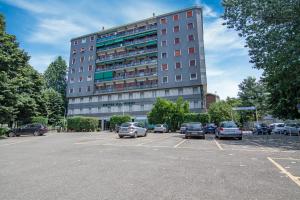 um parque de estacionamento com carros estacionados em frente a um edifício em Hotel Dei Fiori em Milão