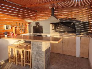 a kitchen with a stone counter and a stove at Hosteria Piedra Blanca in Taltal