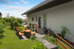 un patio con bancos y una mesa fuera de una casa en Apartments Rikli Rodine near Bled en Rodine