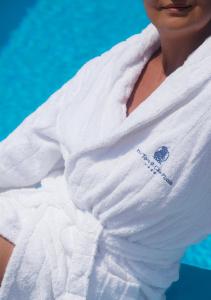 a woman is wrapped in a towel at Boutique Hotel Torre Di Cala Piccola in Porto Santo Stefano