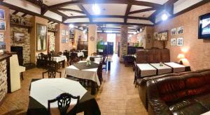 a restaurant with tables and chairs in a room at Міні-готель "ЕКО" in Kamianets-Podilskyi