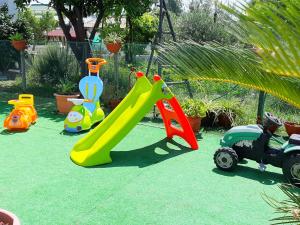 a group of childrens play equipment on a lawn at Garden House Airport in Naples