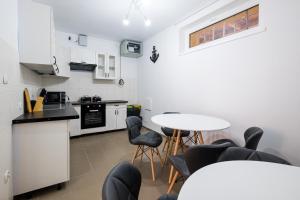 a kitchen with a table and chairs in a room at Przystań Łeba II in Łeba