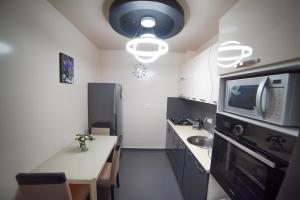 a small kitchen with a sink and a microwave at jako in Batumi