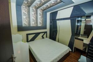 a small bedroom with a bed and a window at jako in Batumi
