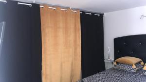 a bedroom with a bed and a wooden curtain at La perle rare in Le Grau-dʼAgde +12 photos