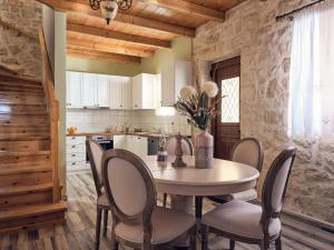 a kitchen and dining room with a table and chairs at Arbarosa Villa in Agios Nikolaos