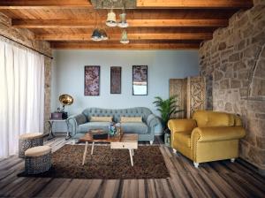 a living room with two couches and a table at Arbarosa Villa in Agios Nikolaos