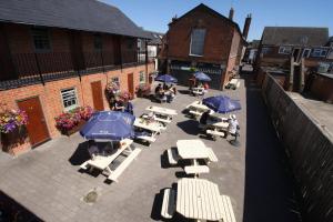 an overhead view of a patio with tables and umbrellas at The Angel in Wootton Bassett in Royal Wootton Bassett