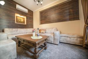 a living room with a couch and a table at Hotel Antique - free private parking in Plovdiv