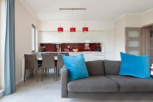 a living room and kitchen with a couch and a table at Elite Apartments Waterlane Swimming Pool&aSpa in Gdańsk