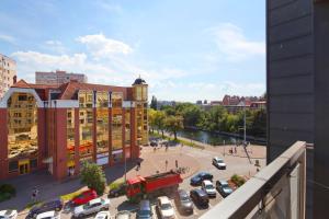 a view of a city with a building and a parking lot at Elite Apartments Waterlane Swimming Pool&aSpa in Gdańsk