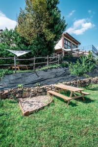 a picnic table in the grass in front of a house at Agriturismo Dai Gobbi in Fara Vicentino