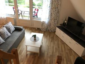 a living room with a couch and a table at Haus Sonnenschein in Timmendorfer Strand