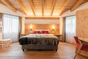 a bedroom with a large bed with red pillows at Löwen Chalets in Seefeld in Tirol