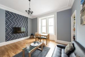 a living room with a couch and a table at City Centre, 5 star Ground Floor in Edinburgh