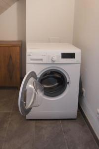 a washing machine with its door open in a room at Ferienwohnung Gehring Bad Krozingen in Bad Krozingen