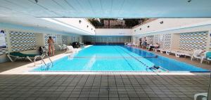 a large swimming pool in a large building at BnBIsrael apartments - Ramat Yam Marine in Herzelia 