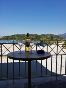 a table with a bottle of wine and two glasses at Verdelis Inn in Ancient Epidauros