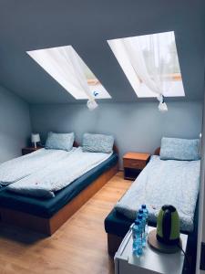 a bedroom with two beds and two skylights at Dom gościnny u Gerliz in Rewal