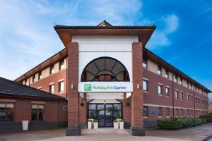 a brick building with a sign that reads hp holiday inn express at Holiday Inn Express Warwick - Stratford-upon-Avon, an IHG Hotel in Warwick