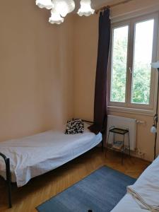 a small bedroom with a bed and a window at Bauhaus Astoria Hostel in Budapest