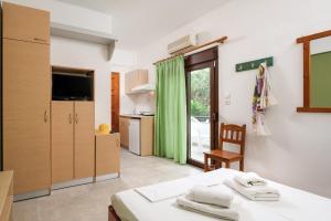 a room with a bed and a kitchen at Fantasia Studios and Apartments in Neos Marmaras