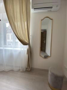 a mirror on a wall next to a window at La Terrasse du Faubourg in Beaune