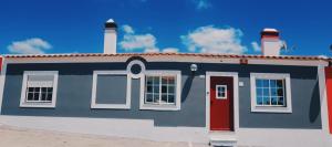 a painting of a house with a red door at Camping Villa Park Zambujeira do Mar in Zambujeira do Mar