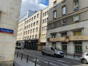 a van parked on a street in front of buildings at Jasna Hostelik in Warsaw