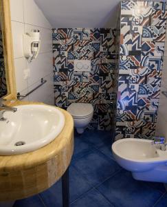 a bathroom with a sink and a toilet at Kavani in Pizzo +28 photos