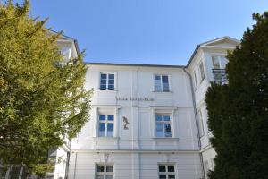 a white building with a sign on it at Villa Lucie Else 06 in Heringsdorf