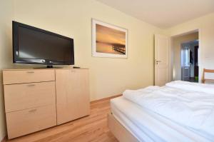 ヘリングスドルフにあるVilla Lamora 01のベッドルーム(ドレッサー内の薄型テレビ付)