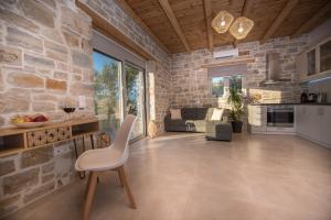 a living room with a stone wall at Irene Komos Independent House in Pitsidia
