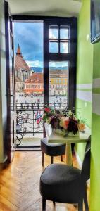 a table with a view of a city from a window at Casa Crown in Braşov