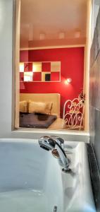 a bathroom with a tub and a bedroom with a bed at Casa Crown in Braşov