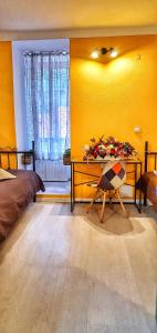 a bedroom with yellow walls and a desk and a bed at Casa Crown in Braşov