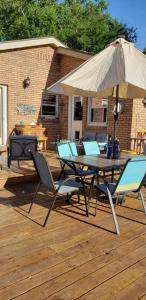 a table and chairs with an umbrella on a deck at Awesome Location, quiet area in Harrisville