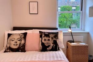 a bedroom with a bed with two pillows on it at Apple Cottage - Central Frome - Outdoor Space in Frome