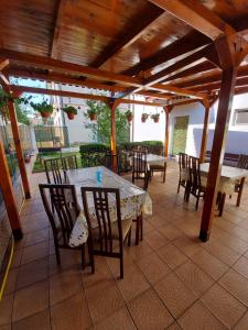 a patio with a table and chairs on a patio at Casa Atlas in Eforie Sud