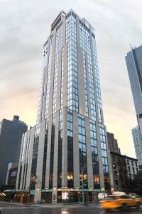 a tall building in the middle of a city at Hyatt House New York/Chelsea in New York